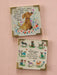 Two framed prints with dog and cat illustrations and text on a pink wall.