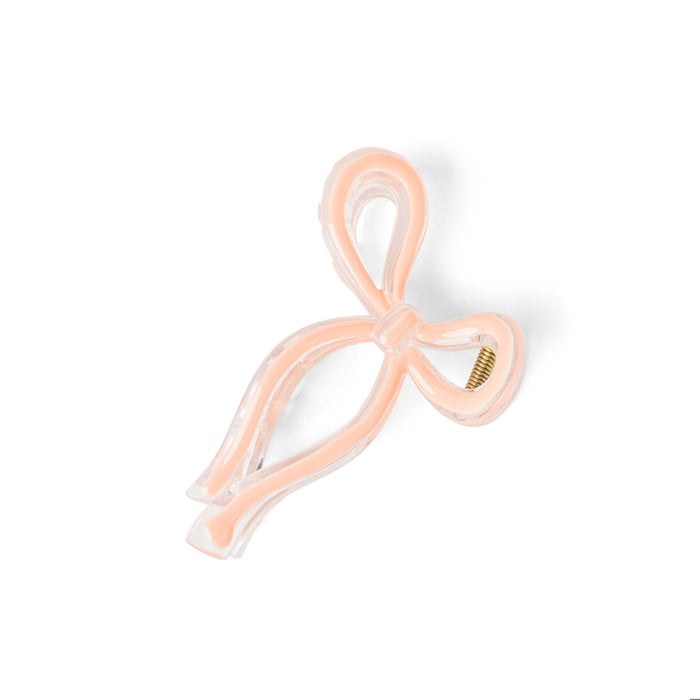 Pink bow-shaped hair clip on a white background