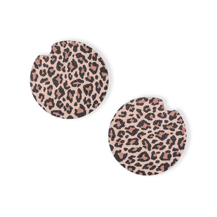 Pair of leopard print car coasters on a white background