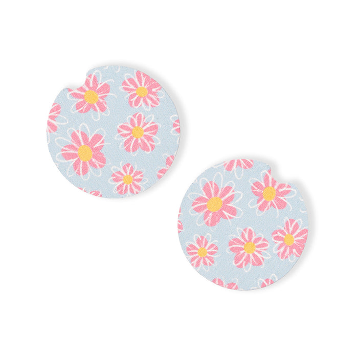 Pair of round earrings with pink floral design on a light blue background
