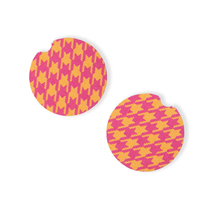 Pair of round earrings with pink and yellow houndstooth pattern on a white background