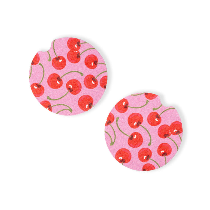 Pair of circular earrings with cherry pattern on pink background