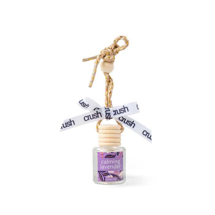 Small bottle labeled 'calming lavender' with a decorative string on a white background