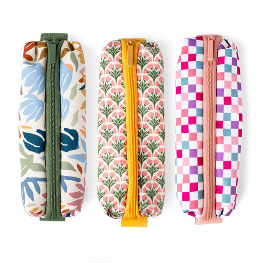 Three colorful patterned pouches with zippers on a white background