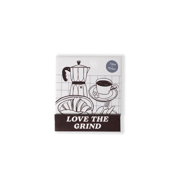 Notebook with coffee-themed illustrations and 'Love the Grind' text on a white background