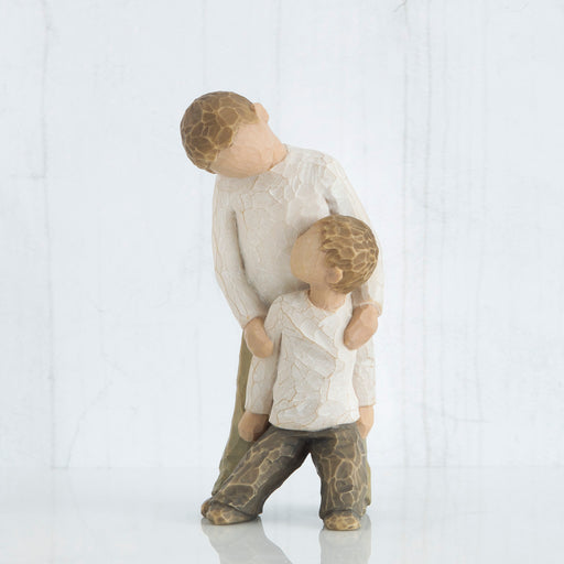 Figure of two boys, younger leaning against the older