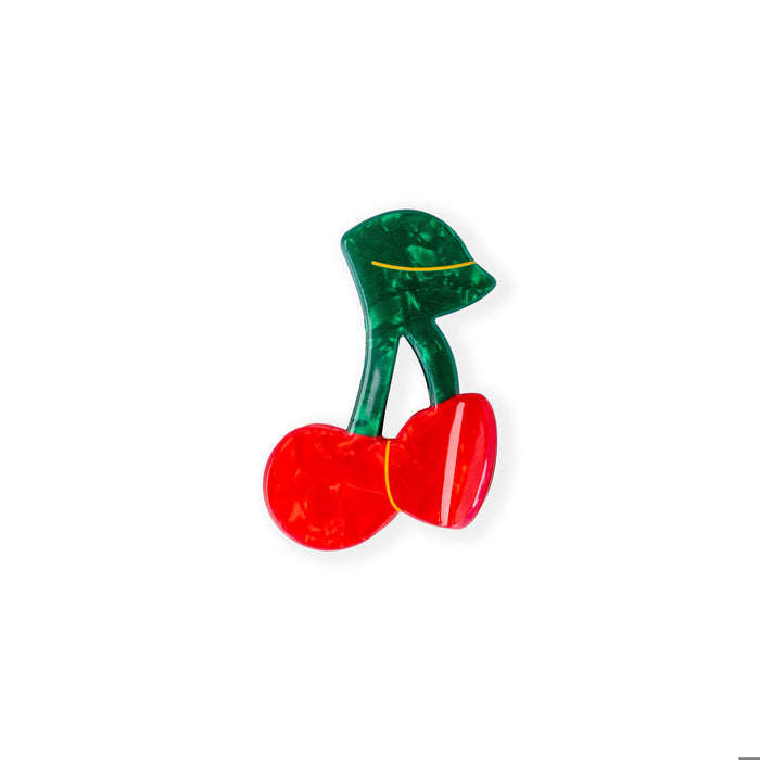 Red and green high-heeled shoe charm on a white background