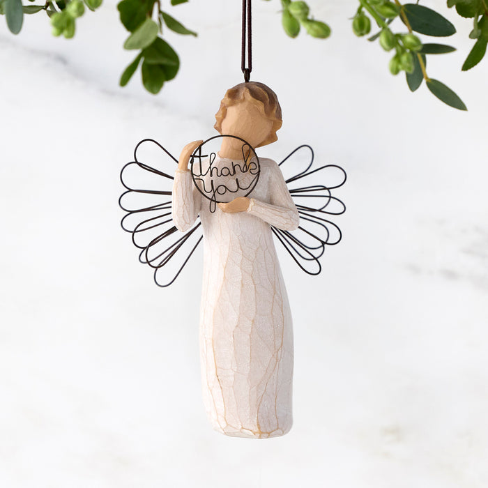 Angel figurine with 'Thank You' message on wings, hanging against a light background