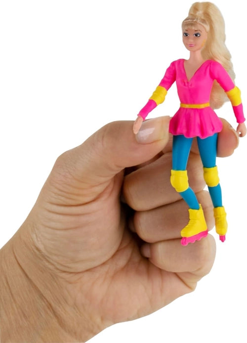 Hand holding a small figurine of a character in a pink dress with blue and yellow accents.