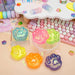 Colorful gelatinous desk accessories on a desk with a keyboard and stationery items.