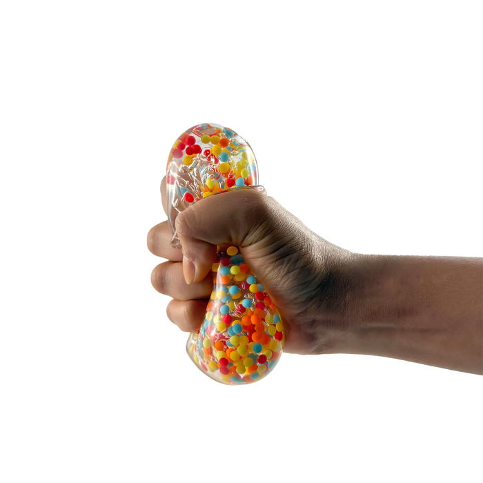 Hand squeezing a stress ball filled with colorful beads on a white background