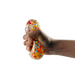 Hand squeezing a stress ball filled with colorful beads on a white background