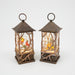 Two decorative lanterns with winter scenes inside on a white background