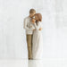 Statue of a couple embracing with a child on a white background