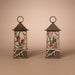 Two decorative lanterns with bird illustrations on a beige background
