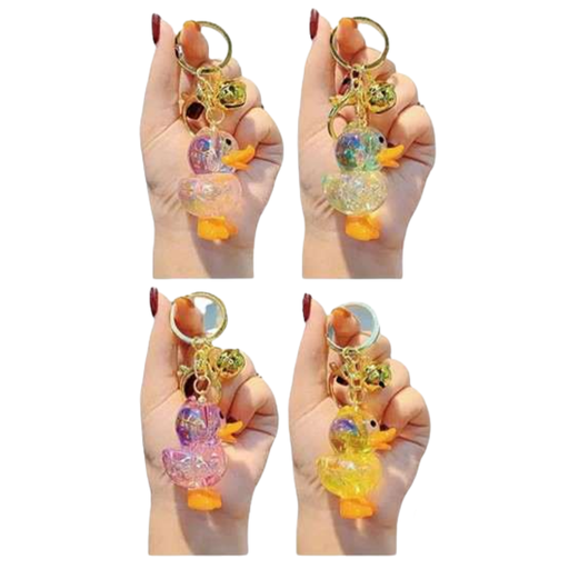 Colorful duck-shaped keychains held by a hand on a white background