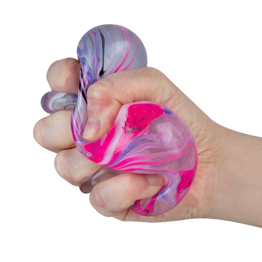 Hand holding a marbled pink and purple stress ball against a white background