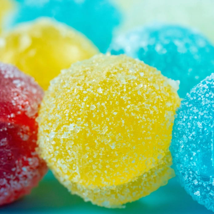 Close-up of colorful gummy candies with a blue background