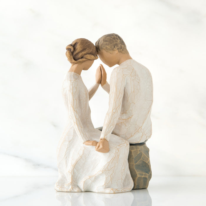 Statue of a couple in a romantic pose on a white background