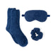 Set of blue fuzzy socks, eye mask, and scrunchie on a white background