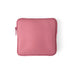 A dusty pink neoprene tablet sleeve with a top zipper and matching zipper pull, shown flat on a white background.