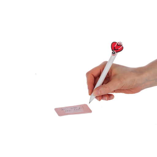 Hand holding a pen with a heart-shaped clip and a small pink notepad on a white background