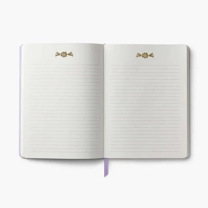 Open notebook with lined pages and decorative rose stickers on a white background