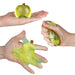 Hands interacting with a yellow gel-like substance on a white background