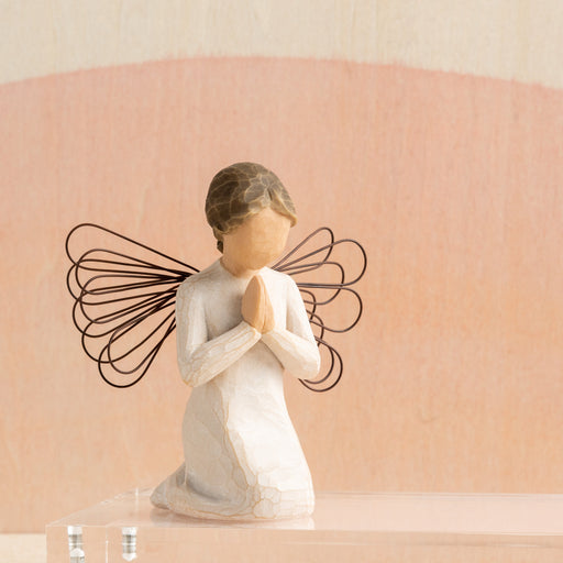 Statue of a angel with butterfly wings on a beige background