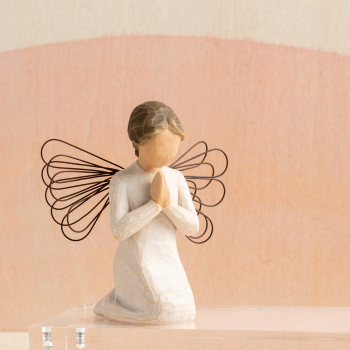 Statue of a angel with butterfly wings on a beige background