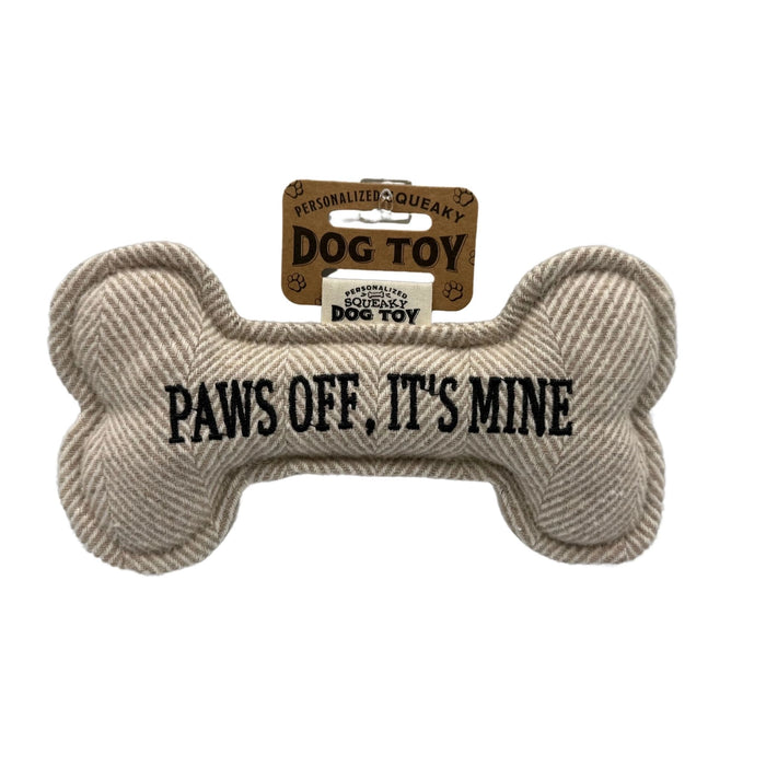 Bone shaped dog toy that says 'PAWS OFF, IT'S MINE' on a white background