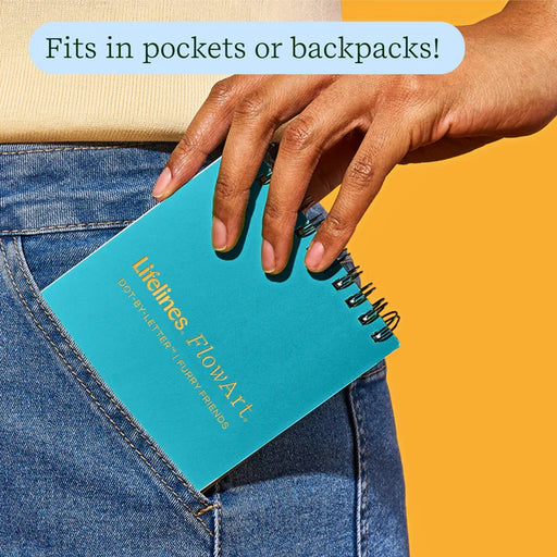 Person placing a teal notebook with 'Lifelines FlowArt' branding into a pocket against an orange background.