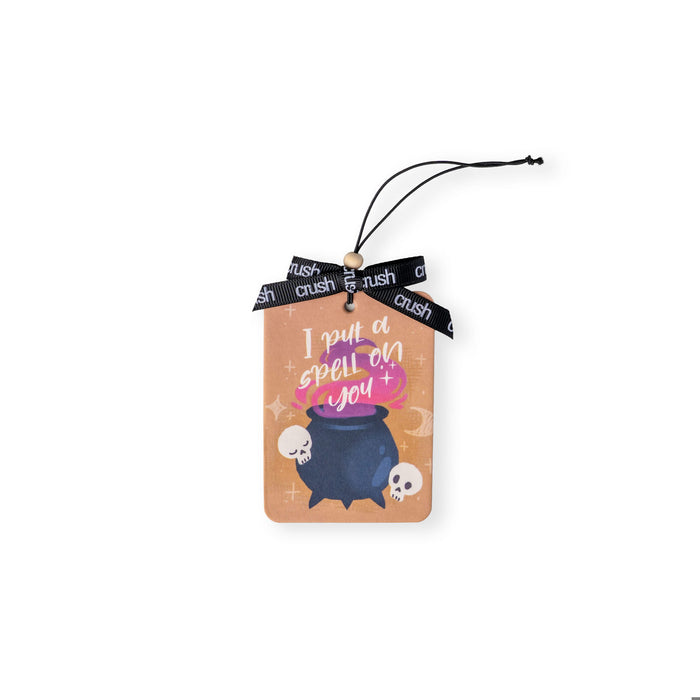 Decorative tag with a witch's cauldron design and text on a white background