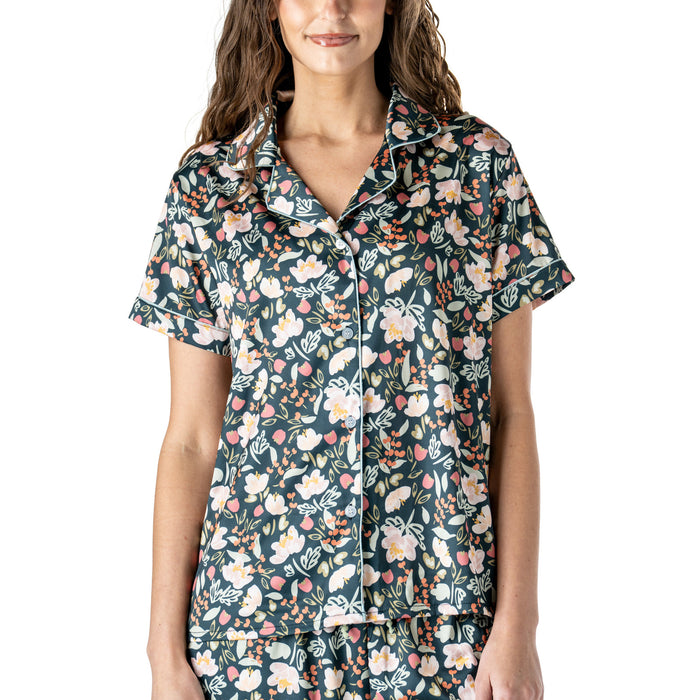 Woman wearing a floral patterned shirt on a white background