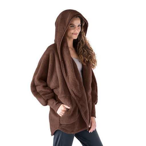 Woman wearing a brown hooded sweater on a white background