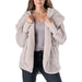 Woman wearing a light gray sherpa jacket on a white background