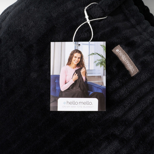 Black knit blanket with a tag featuring a woman holding a baby, branded 'hello mello'.