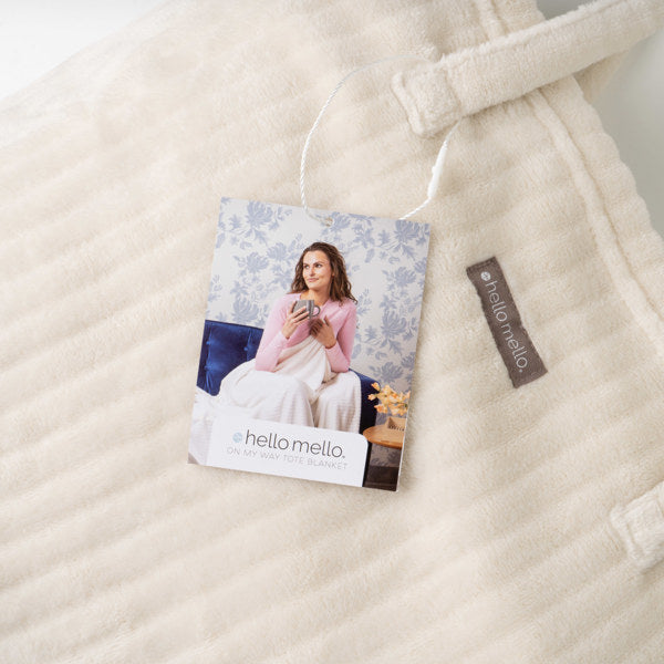 Beige quilt with a tag and label on a neutral background