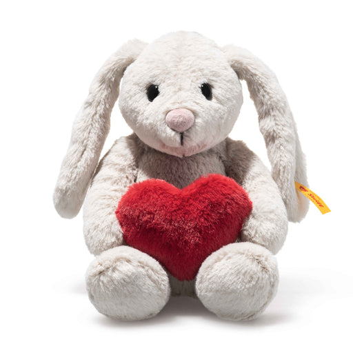 Plush bunny toy with a red heart on a white background
