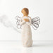 Standing angel in cream dress with wire wings, with crossed hands under small gold-leaf heart. Dress carved with symbols of nature