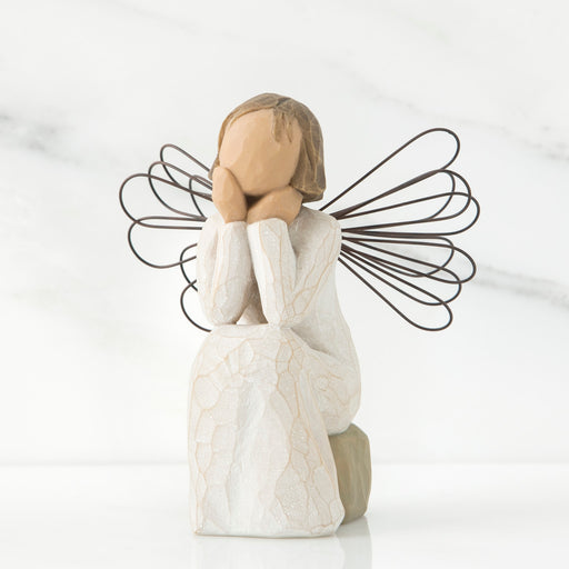 Angel figurine with wire wings on a white background