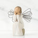 Angel figurine with wire wings on a white background