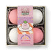 A boxed set of four soft squishy sensory toys shaped like mochi, with two pink and two white round pieces arranged in a clear plastic tray. A pink paper band wraps around the center, featuring cartoon mochi artwork and the text 'KAWAII MOCHI' and 'SUPER SQUISHY'.