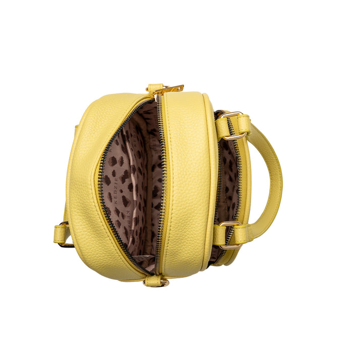 Yellow handbag with leopard print interior on a white background