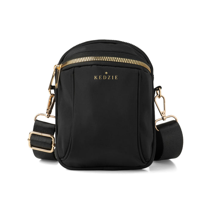 Black crossbody bag with gold accents on a white background