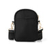Black crossbody bag with gold hardware on a white background