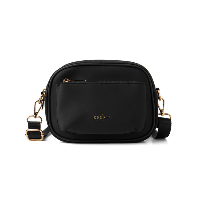 Black handbag with gold accents on a white background
