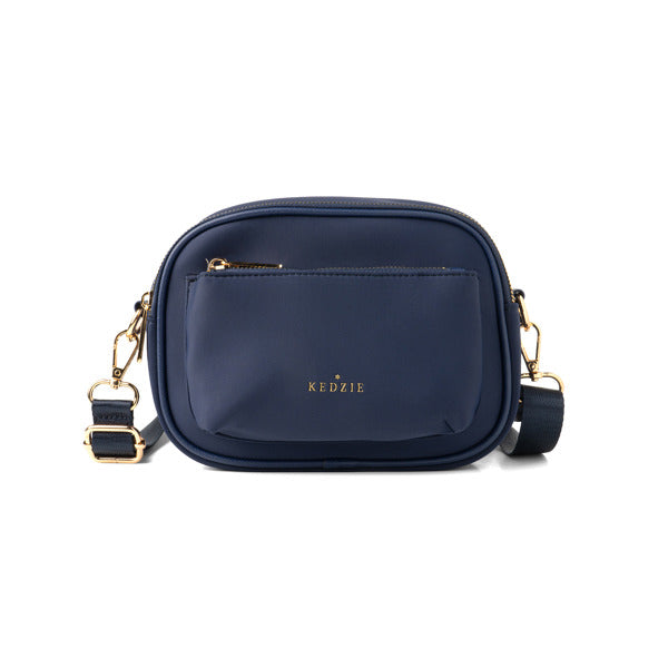 Navy blue handbag with gold accents on a white background