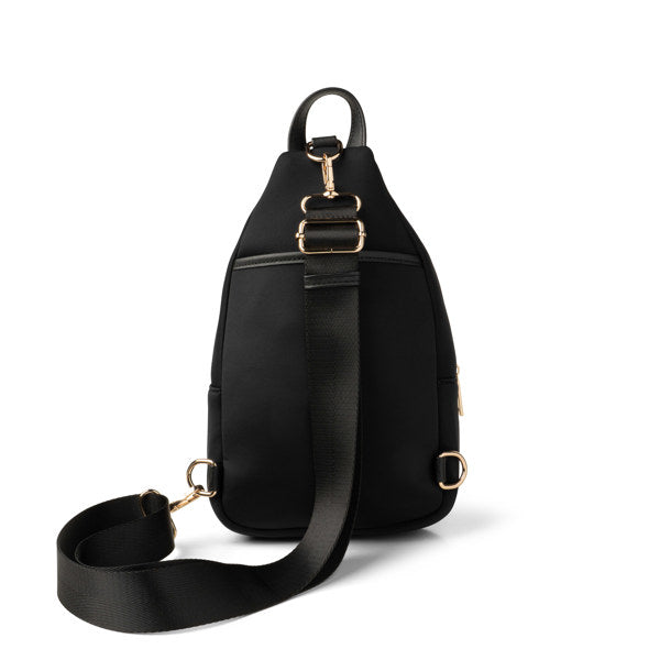 Black sling bag with gold hardware on a white background