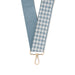 Two fabric straps, one solid blue and one houndstooth patterned, on a white background.